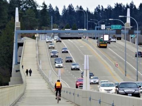 A cyclist rides across Lake Washington on the SR 520 Trail.