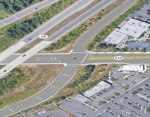 An aerial view of SR 516 where it crosses beneath the elevated SR 18. The roadways intersect just outside of town. 