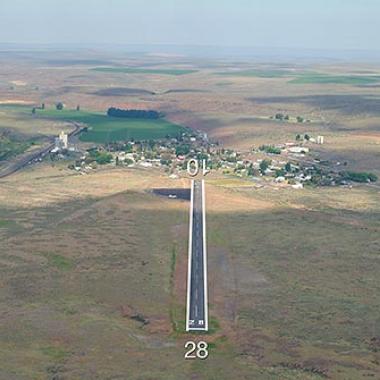 The runway at Wilson Creek airport with fields stretching in the distance. 