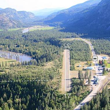 This Avey Field airport runway is nestled inbetween the trees and roadway,