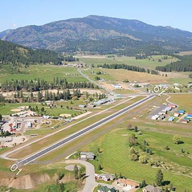 Colville Airport runway located on flat grasslands. 