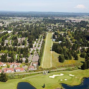 Hoskins Field airport located near a field and residential area.