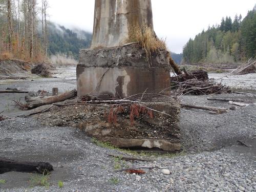 Bridge piers which were discovered to be built on gravel, not bedrock. Erosion has significantly damaged the piers after the river changed course and flow over the years.