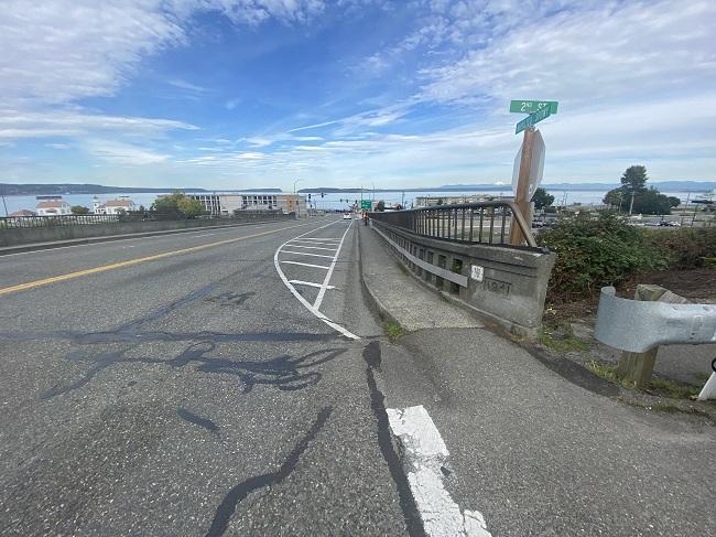 View of northbound lanes of SR 525 with ferry vehicle holding lane and adjacent sidewalk